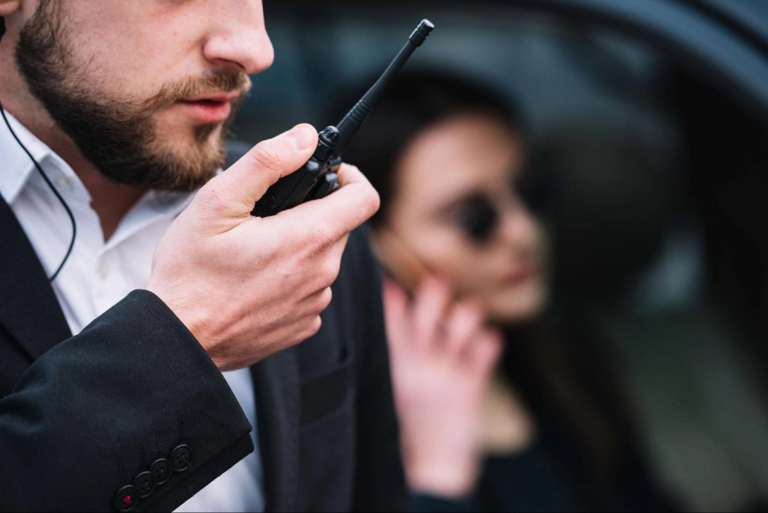 Close-up of security professional communicating via radio during VIP protection – American Security Force providing executive protection services