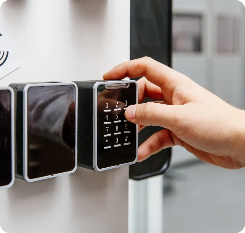 Person using a keypad as part of electronic access control systems for secure entry.
