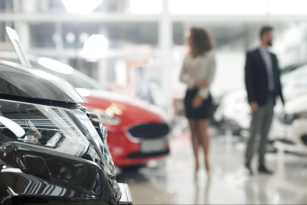 Car Dealership Security Services | American Security Force (ASF) Car dealership showroom with vehicles on display and customers browsing, protected by professional car dealership security services from American Security Force.