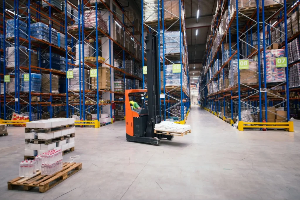 Warehouse Security Guard Patrol & Asset Protection Services | American Security Force (ASF) Forklift operating inside a large warehouse with organized inventory racks, highlighting warehouse security guard patrol and asset protection services by American Security Force.