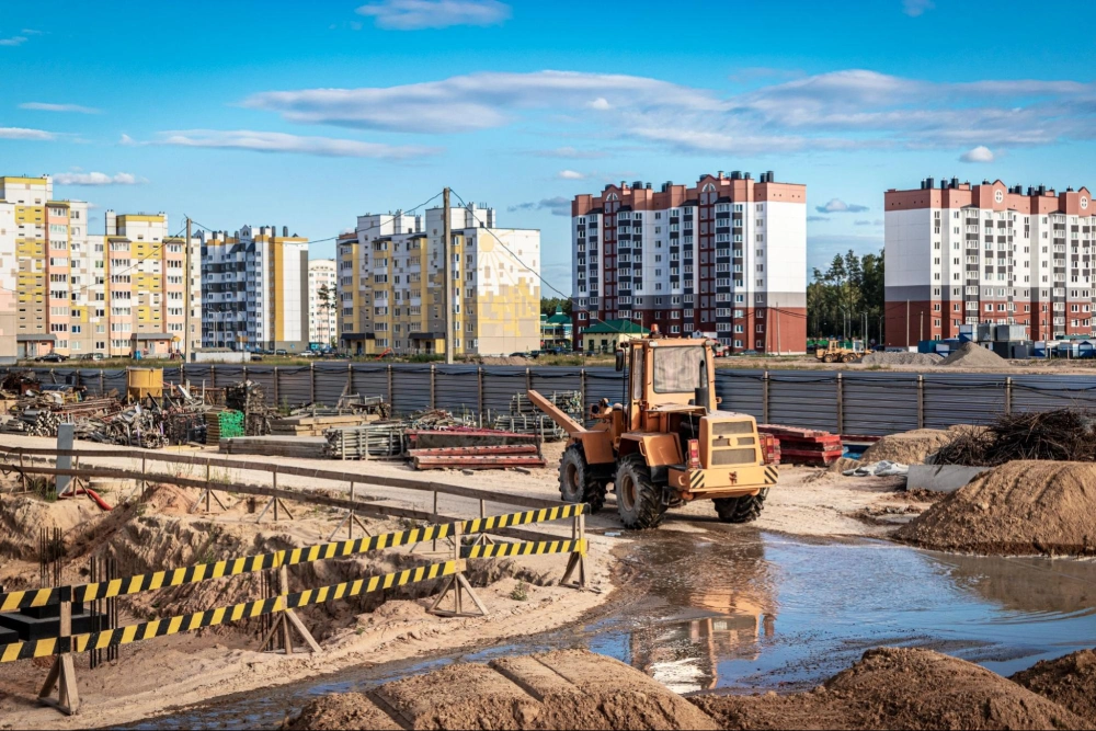 Secure Your Construction Site with American Security Force Security Solutions Construction site with heavy machinery and apartment buildings in the background, showcasing the need for professional construction site security by American Security Force.
