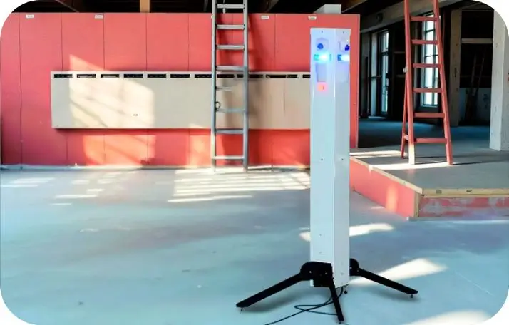Sentinel Surveillance A white, tall Sentinel mobile surveillance tower with glowing blue and orange lights, set up indoors at an industrial site, demonstrating rapid-deployment site security capabilities.