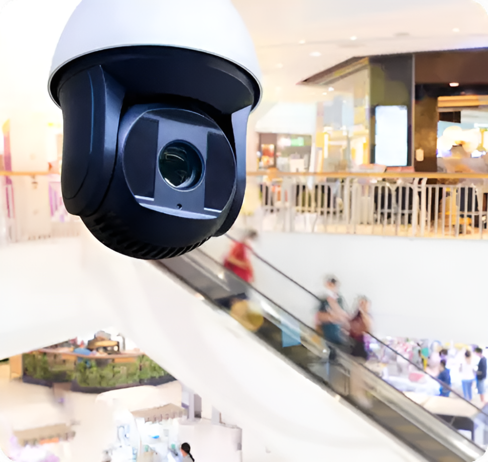 High-definition surveillance camera monitoring shoppers in a retail mall, representing American Security Force's retail security services