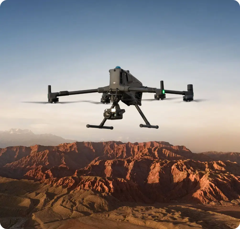 Surveillance drone flying over rugged desert mountains for aerial security monitoring