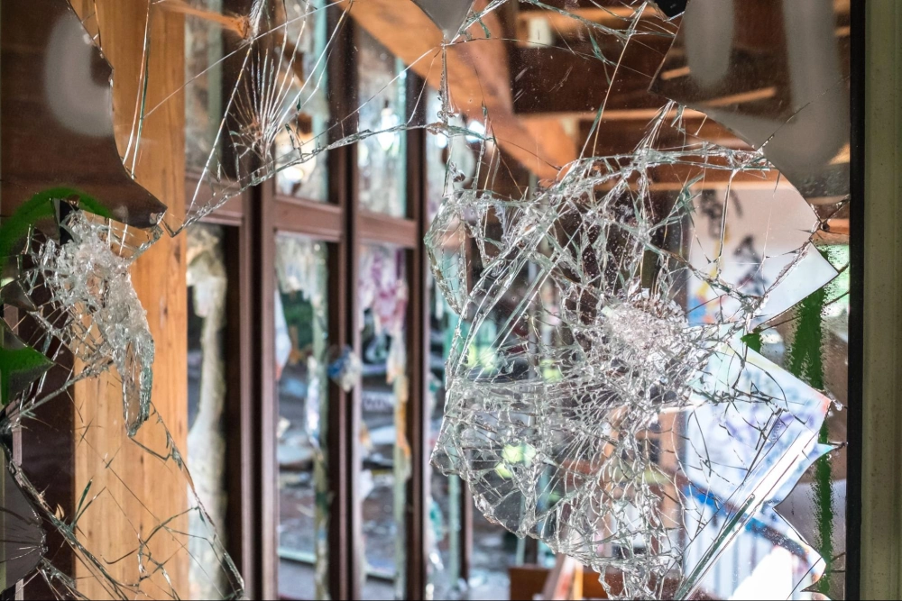 Protect Your Commercial Property from Vandalism with American Security Force Shattered glass door after a break-in, emphasizing the need for reliable commercial property security and vandalism prevention by American Security Force.