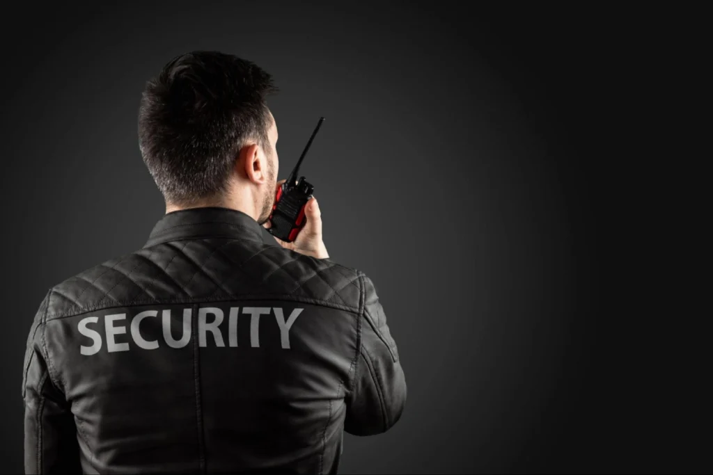 Professional security guard using two-way radio for communication – American Security Force ensures reliable protection services