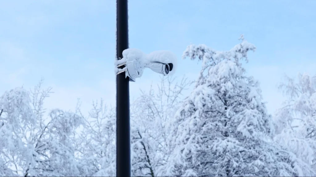 Winter Surveillance Challenges and Solutions – American Security Force Outdoor security camera covered in snow during winter, highlighting the importance of weather-resistant surveillance systems