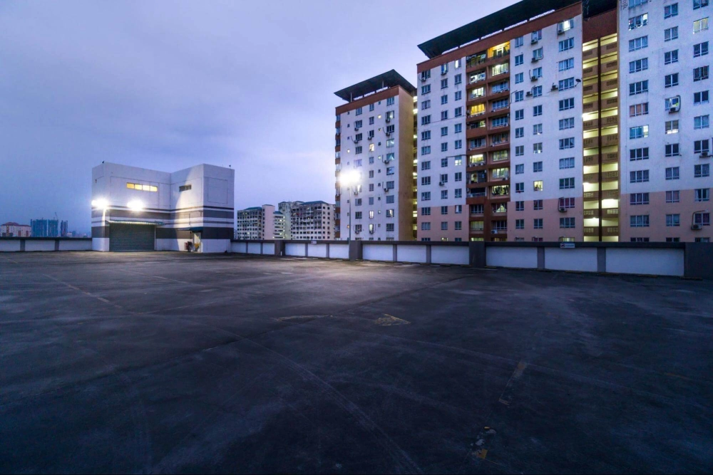 American Security Force providing apartment building and parking structure security for a residential complex at dusk