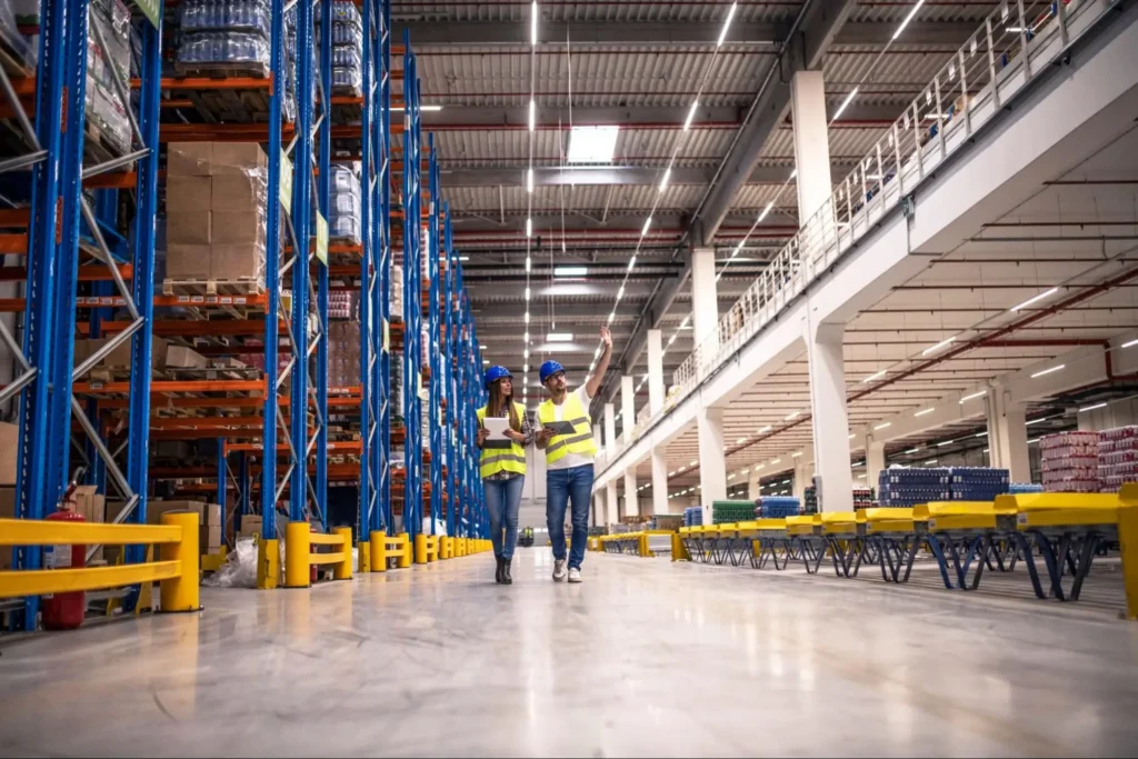 Warehouse workers conducting security and inventory inspection in large logistics facility by American Security Force