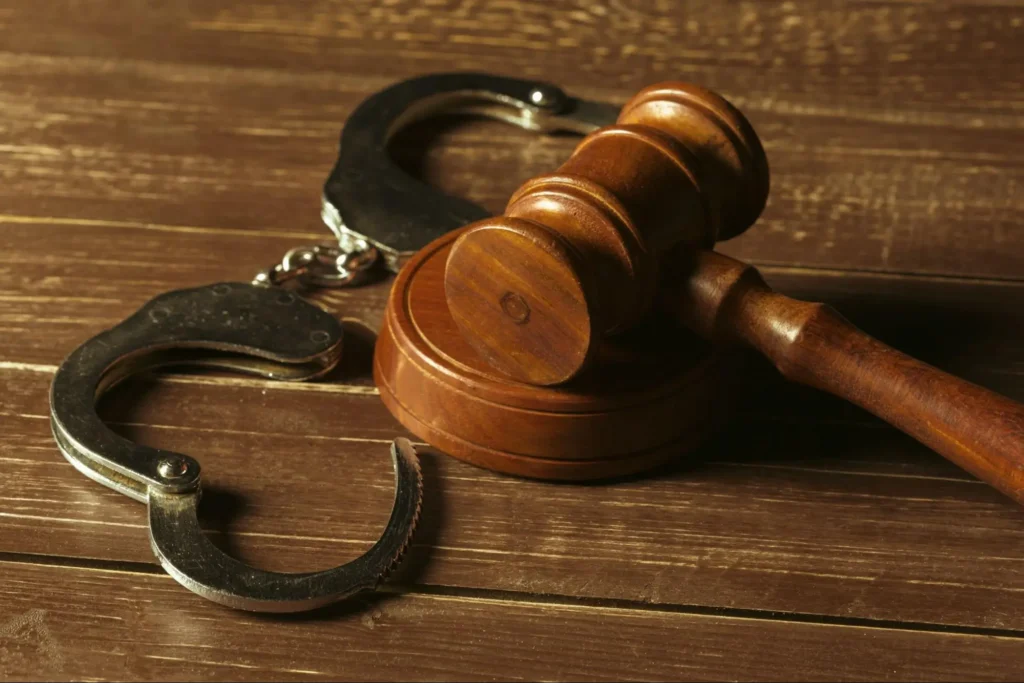 Criminal Justice and Security Investigation Judge gavel and handcuffs representing criminal justice, legal proceedings, and security investigations.